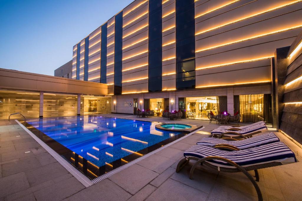 a large swimming pool in front of a building at Braira Qurtubah in Riyadh