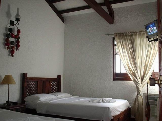 Postel nebo postele na pokoji v ubytování Hotel Campestre Mucura