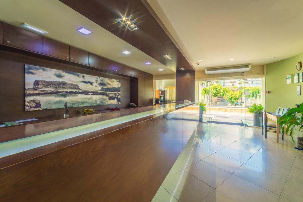 a lobby with a large painting on the wall at Atrion Resort Hotel in Agia Marina Nea Kydonias