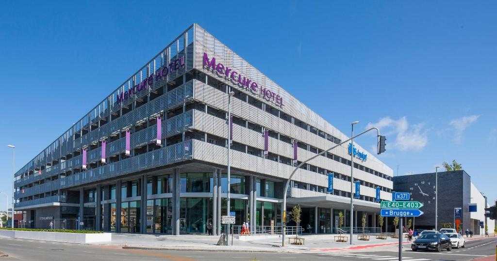 a large building with a sign on the side of it at Mercure Blankenberge in Blankenberge