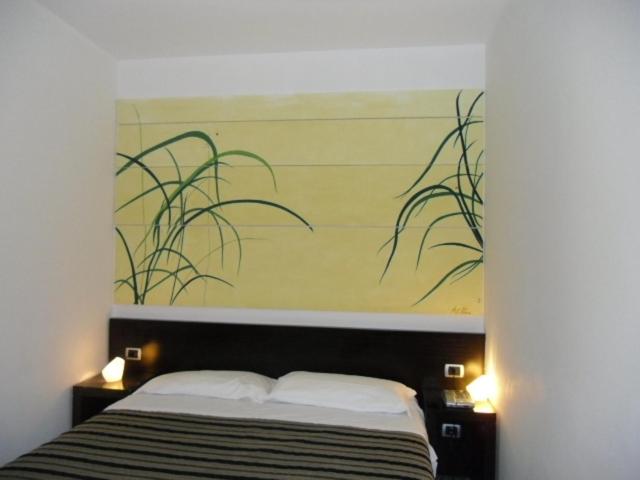 Postel nebo postele na pokoji v ubytování Hotel Zeffiro