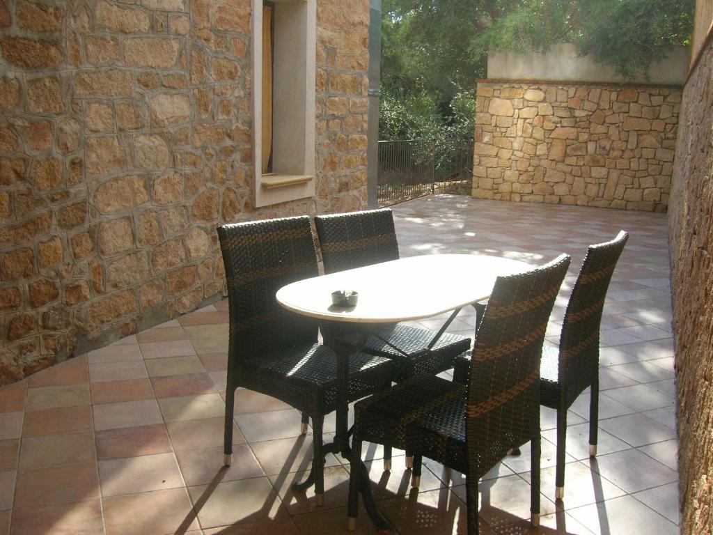 a table and chairs sitting on a patio at Nascar Hotel in Santa Maria Navarrese