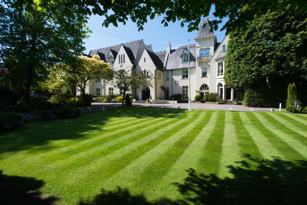 a large lawn in front of a house at Glen-Yr-Afon House Hotel in Usk