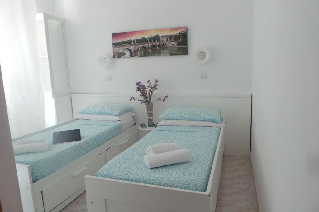 Postel nebo postele na pokoji v ubytování Hotel Castelfidardo