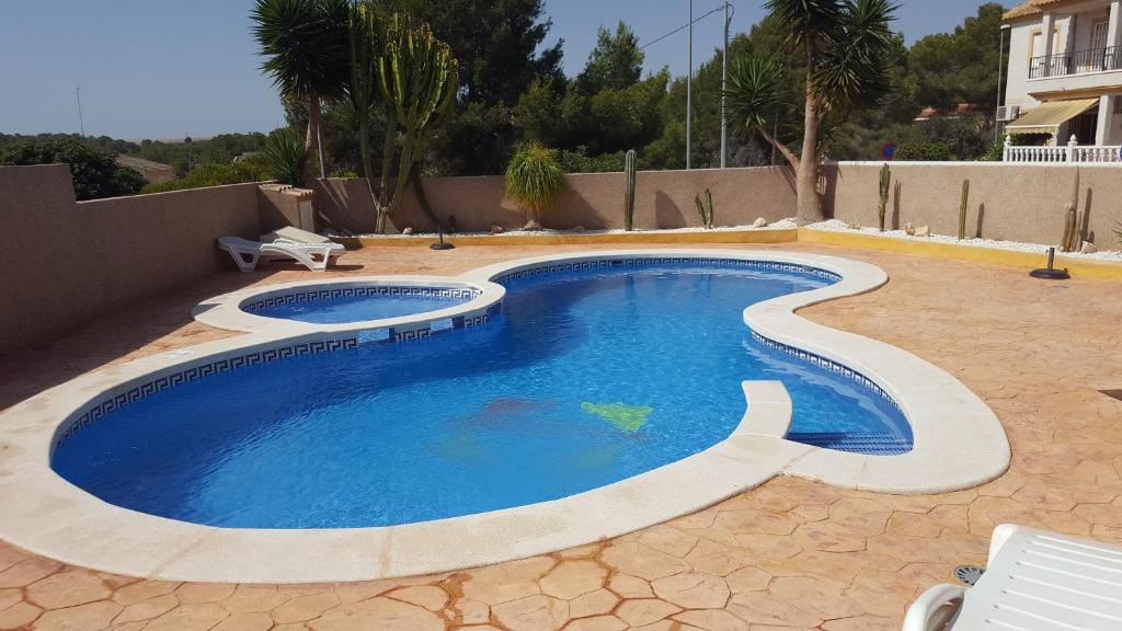 een zwembad in een tuin met een patio bij Casa Horadada in Algorfa