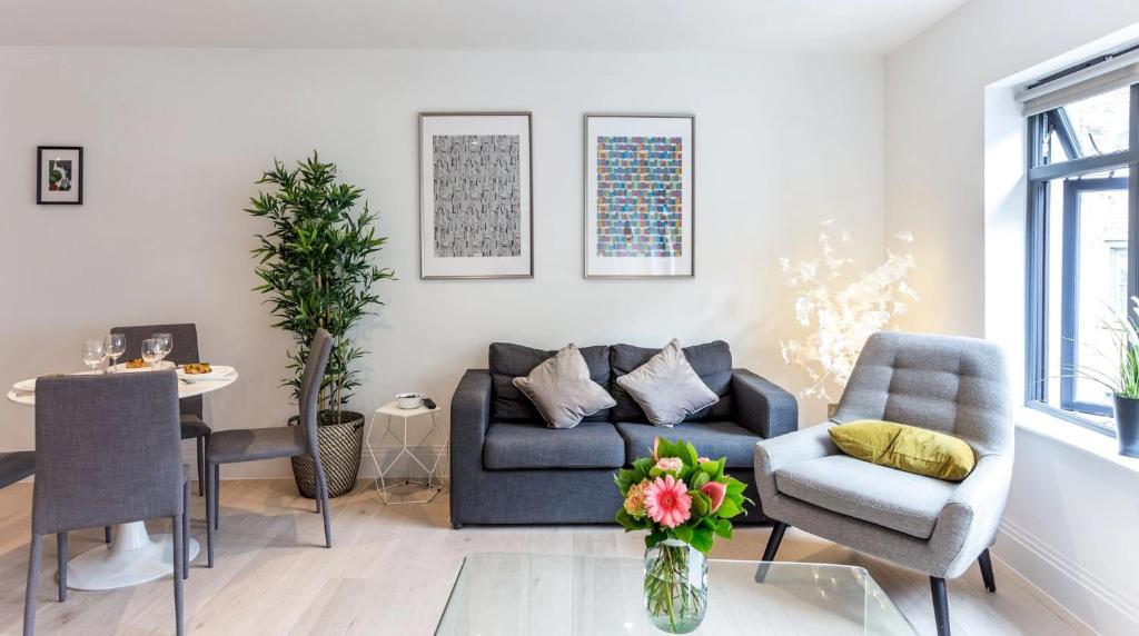 a living room with a couch and a table at Oxford Circus Apartments in London