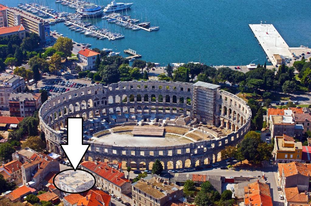 an aerial view of a large building next to a harbor at Apartment Next To Amphitheatre in Pula
