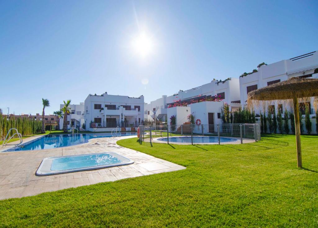 a resort with a swimming pool and a building at Mar de Pulpí Costa de Almeria by Mar Holidays in San Juan de los Terreros