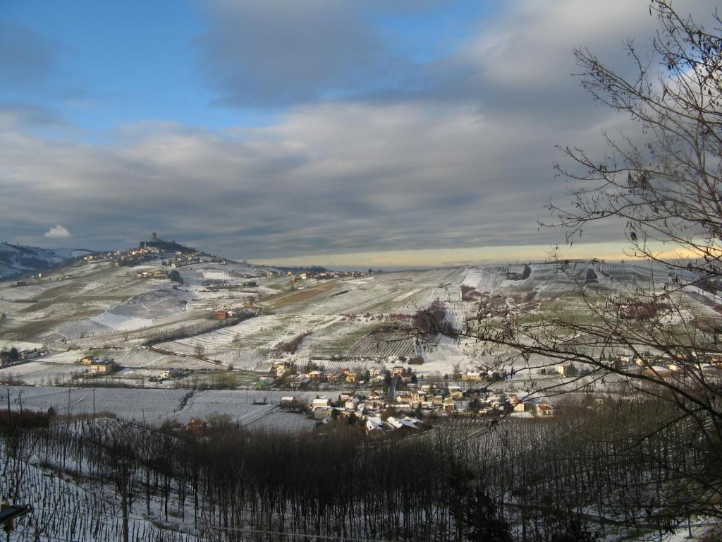 a town on a hill with snow on the ground at Delightful Home-Lovely Hill View in Canneto Pavese