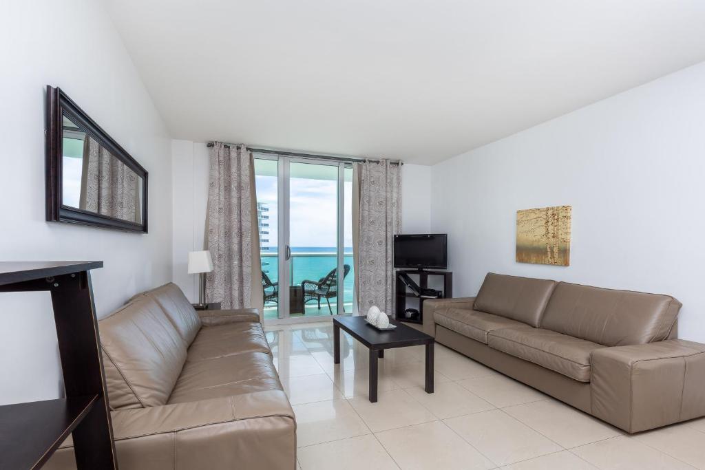 a living room with a couch and a view of the ocean at Ocean Front 1 bedroom at Tides Hollywood 11th in Hollywood