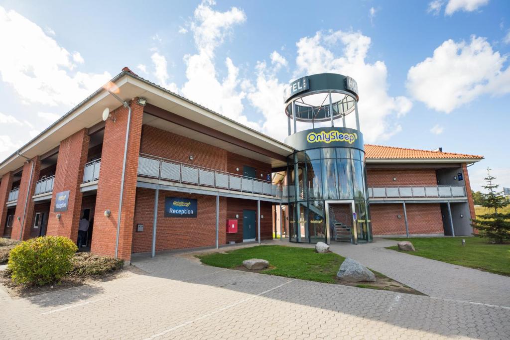 a building with a clock tower on top of it at OnlySleep Trafikcenter in Slagelse