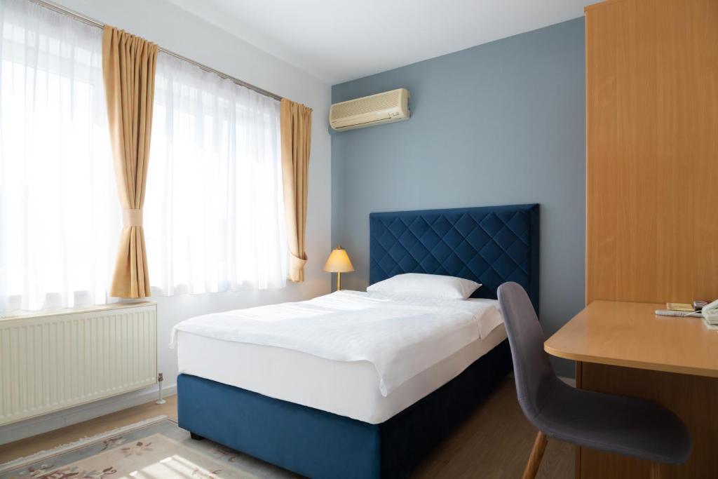 Postel nebo postele na pokoji v ubytování Hotel Vila Tina