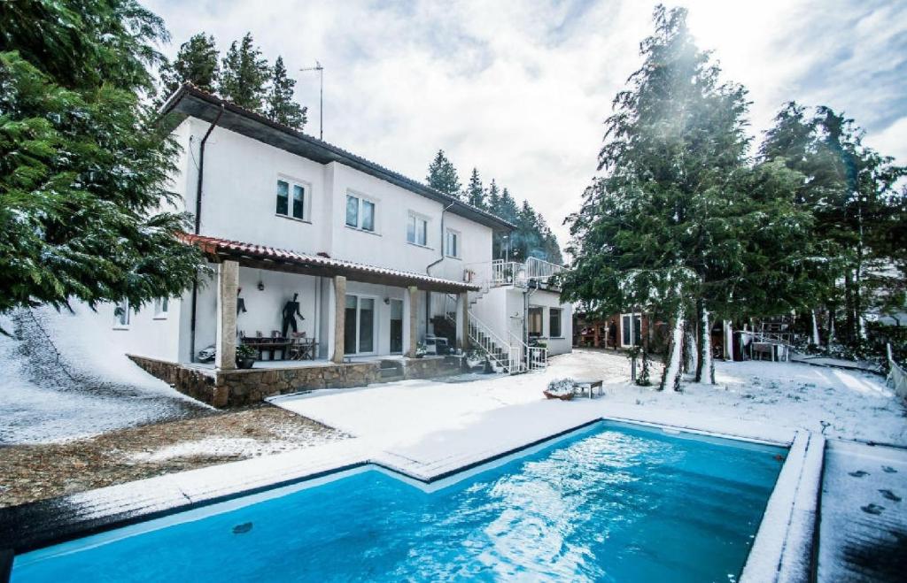 a house with a swimming pool in the snow at Casa Avó Chiquinha in Montalegre
