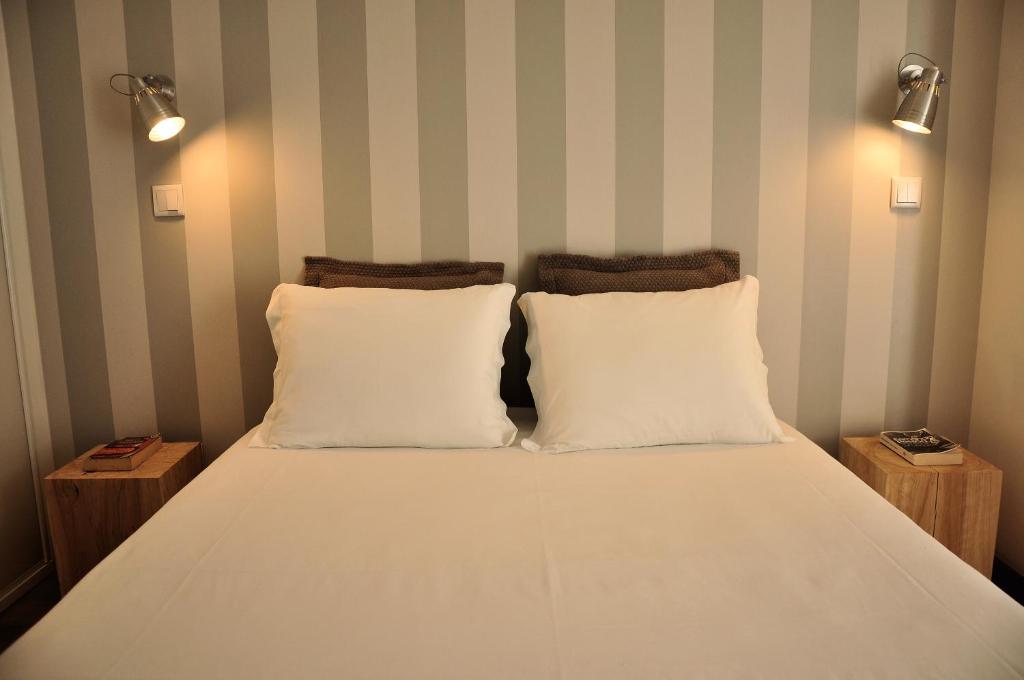 a bed with two white pillows in a room at PicPorto Apartment in Porto