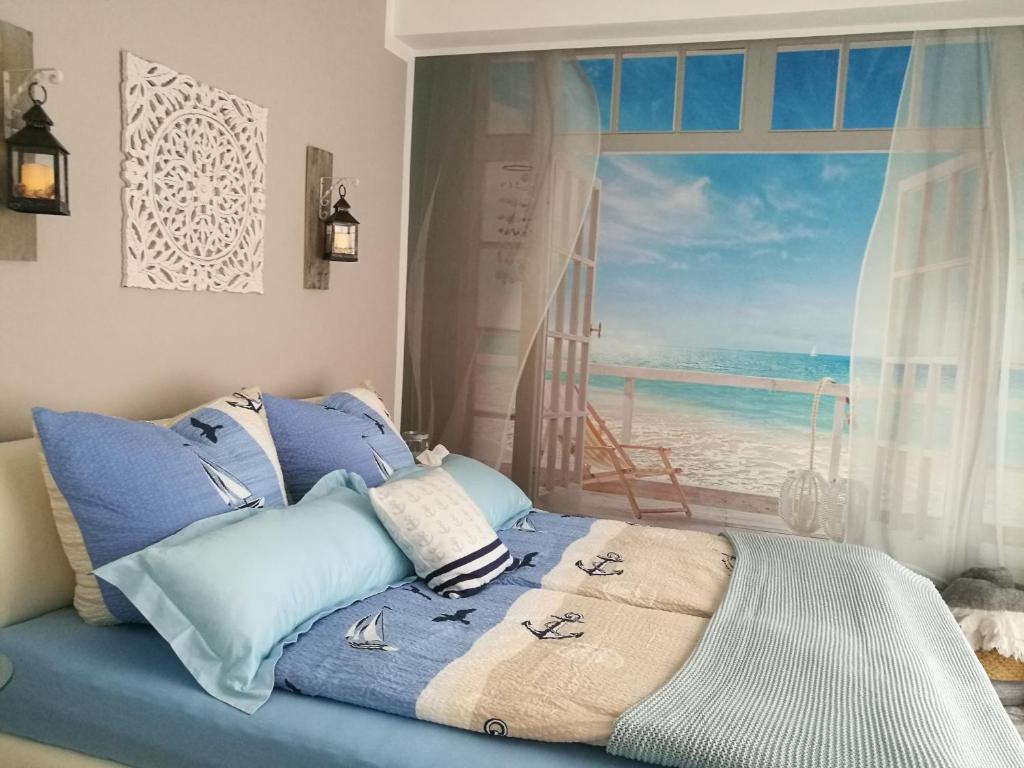 a bedroom with a bed with a view of the ocean at Ferienwohnung Südterrasse mit Kamin Bj 2019 in Timmendorfer Strand