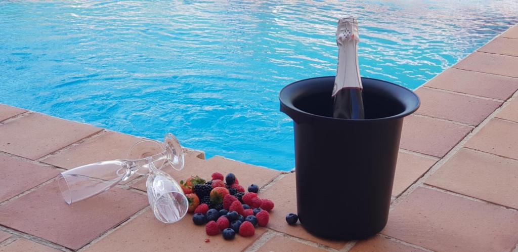 a black trash can sitting next to a swimming pool at Casa La Noria in Nerja