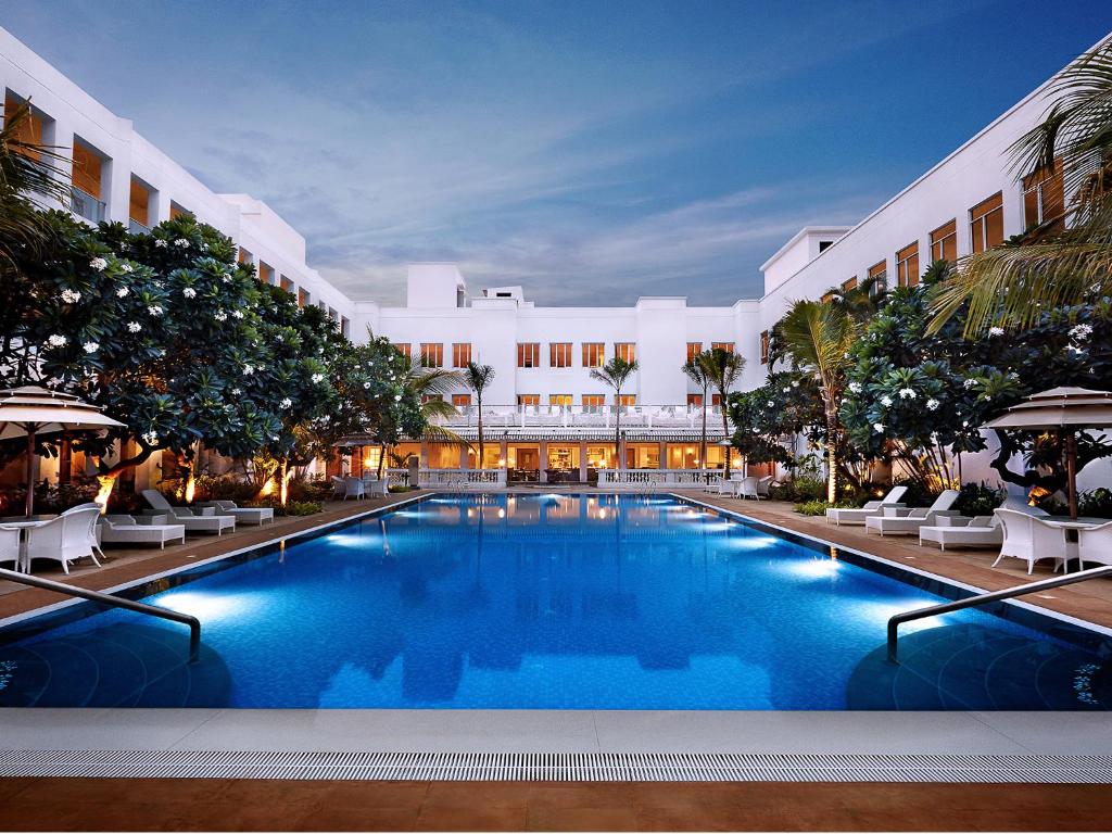a large swimming pool in front of a building at Taj Connemara, Chennai in Chennai