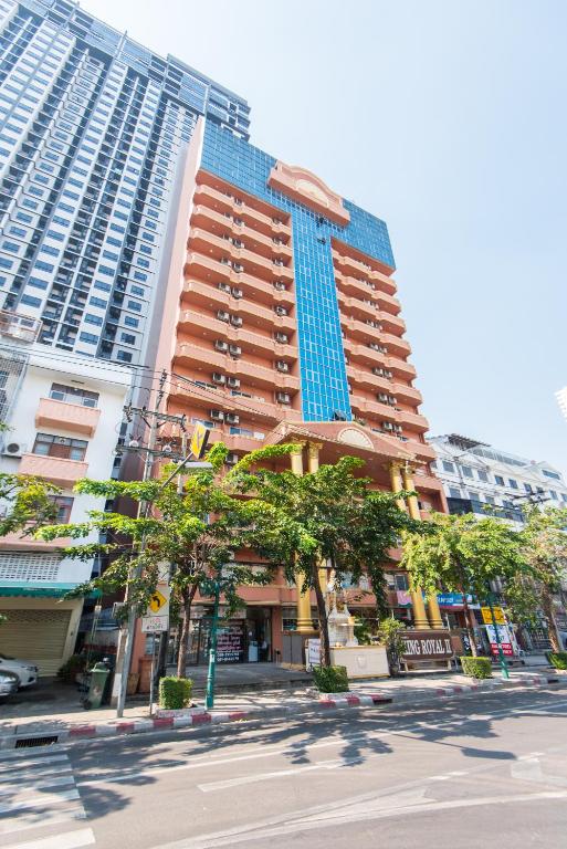 a tall building with trees in front of it at King Royal 2 in Bangkok