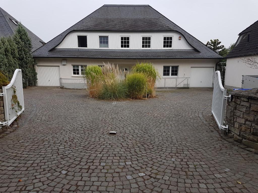 a house with a driveway in front of a house at Wohnen im Souterrain einer Villa in Herdecke