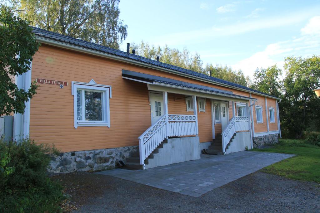 a building with stairs and a porch on it at Savonlinnan Kansanopisto - Wanha Pappila in Savonlinna