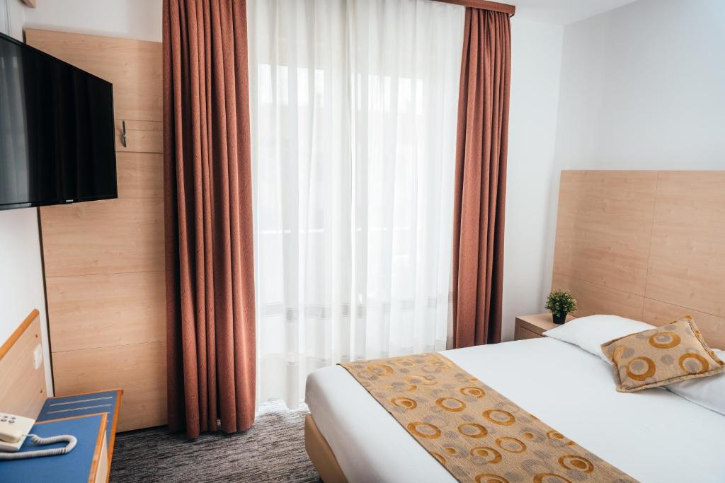 Postel nebo postele na pokoji v ubytování Hotel Delfin