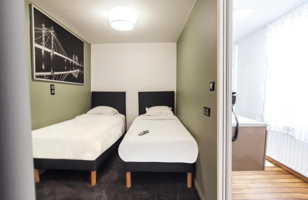 Postel nebo postele na pokoji v ubytování Cit'Hotel B Hotel Brasserie