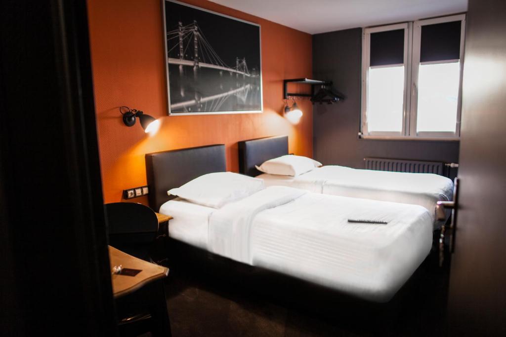 Postel nebo postele na pokoji v ubytování Cit'Hotel B Hotel Brasserie