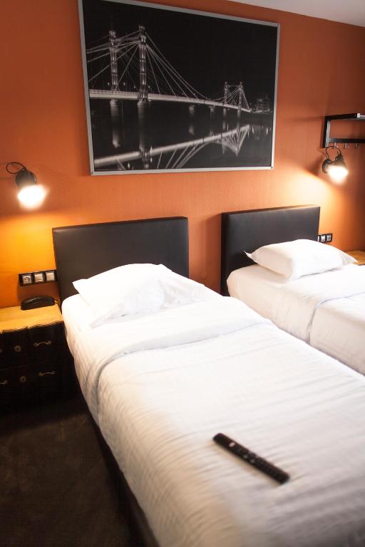 Postel nebo postele na pokoji v ubytování Cit'Hotel B Hotel Brasserie