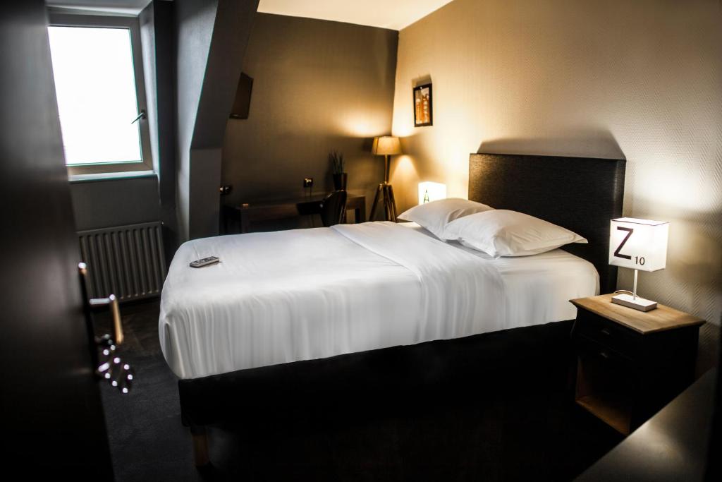 Postel nebo postele na pokoji v ubytování Cit'Hotel B Hotel Brasserie