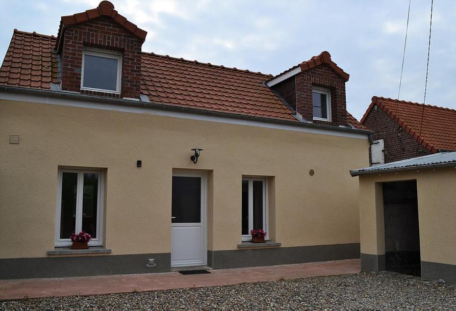 a house with two windows and a white door at Le Nid Des Grands Geais in Le Crotoy