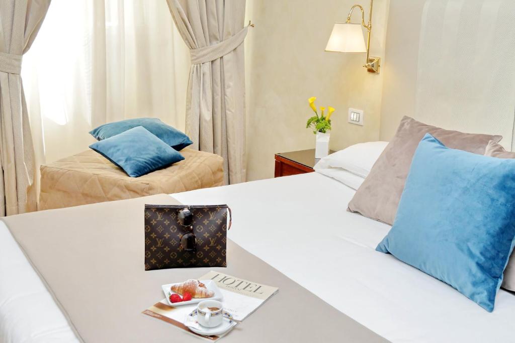 Postel nebo postele na pokoji v ubytování Hotel Camelia