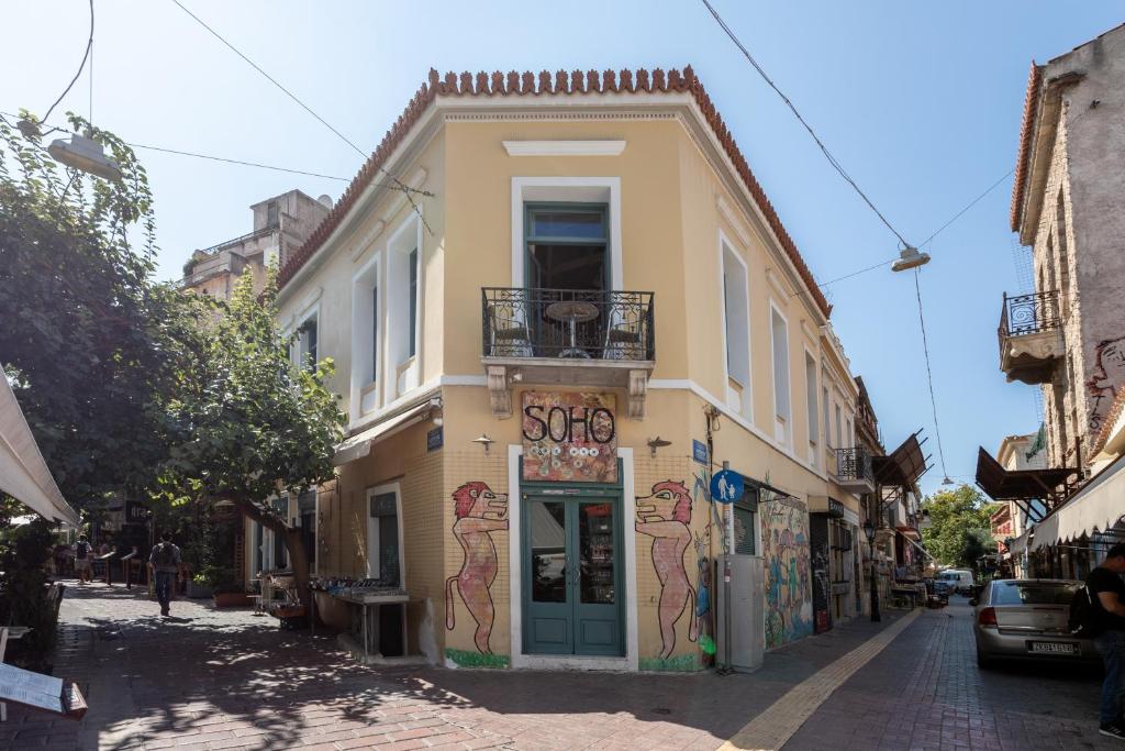 a building with graffiti on it on a street at Ancient Agora Apartments in Athens