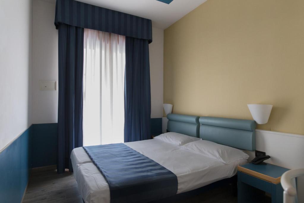 Postel nebo postele na pokoji v ubytování Hotel Christian