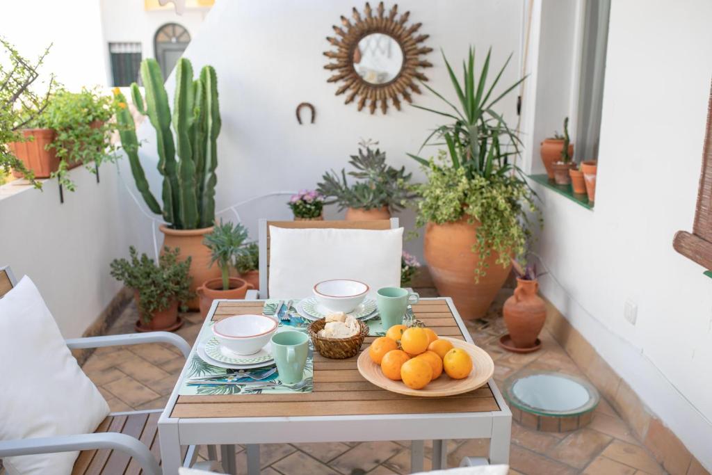 a table with a bowl of oranges on it at Cosy Apartment with Terrace in the Centre of Seville in Seville