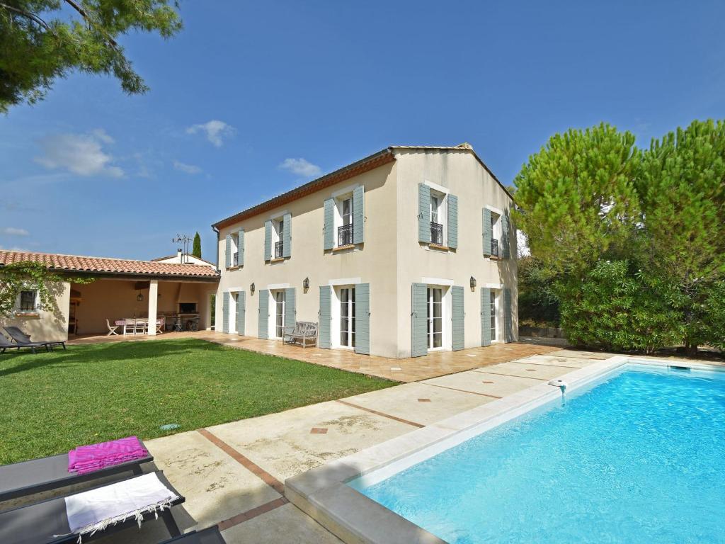 een groot huis met een zwembad ervoor bij Villa Bastide d Or in Campagnan