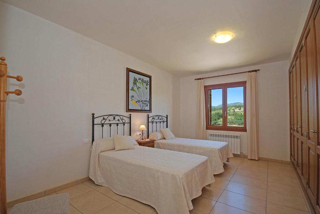Postel nebo postele na pokoji v ubytování Villa Blanquerna
