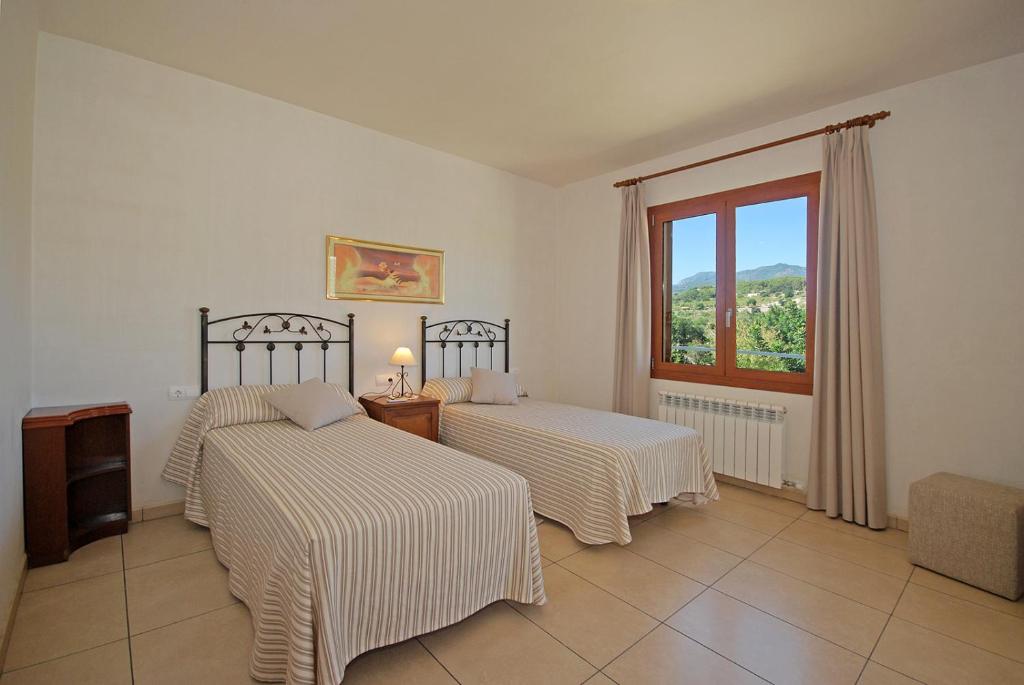 Postel nebo postele na pokoji v ubytování Villa Blanquerna