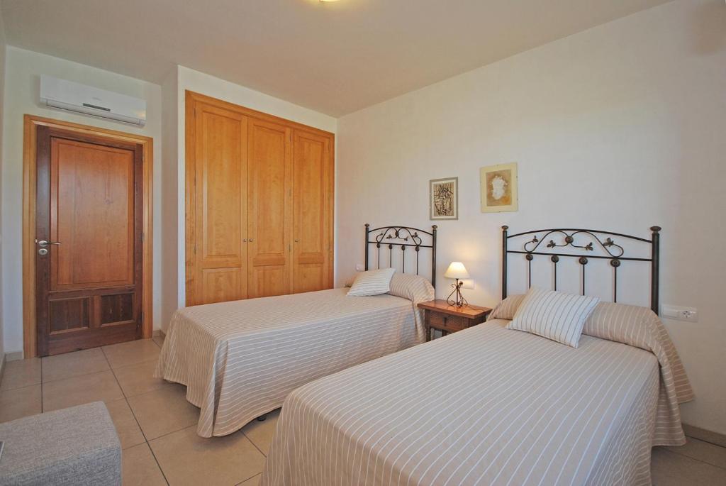 Postel nebo postele na pokoji v ubytování Villa Blanquerna