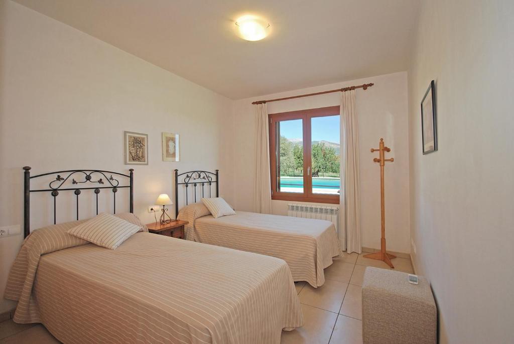 Postel nebo postele na pokoji v ubytování Villa Blanquerna