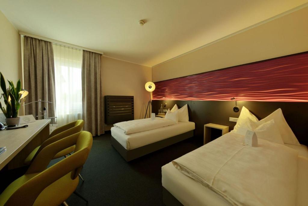 Кровать или кровати в номере DION Hotel Villach