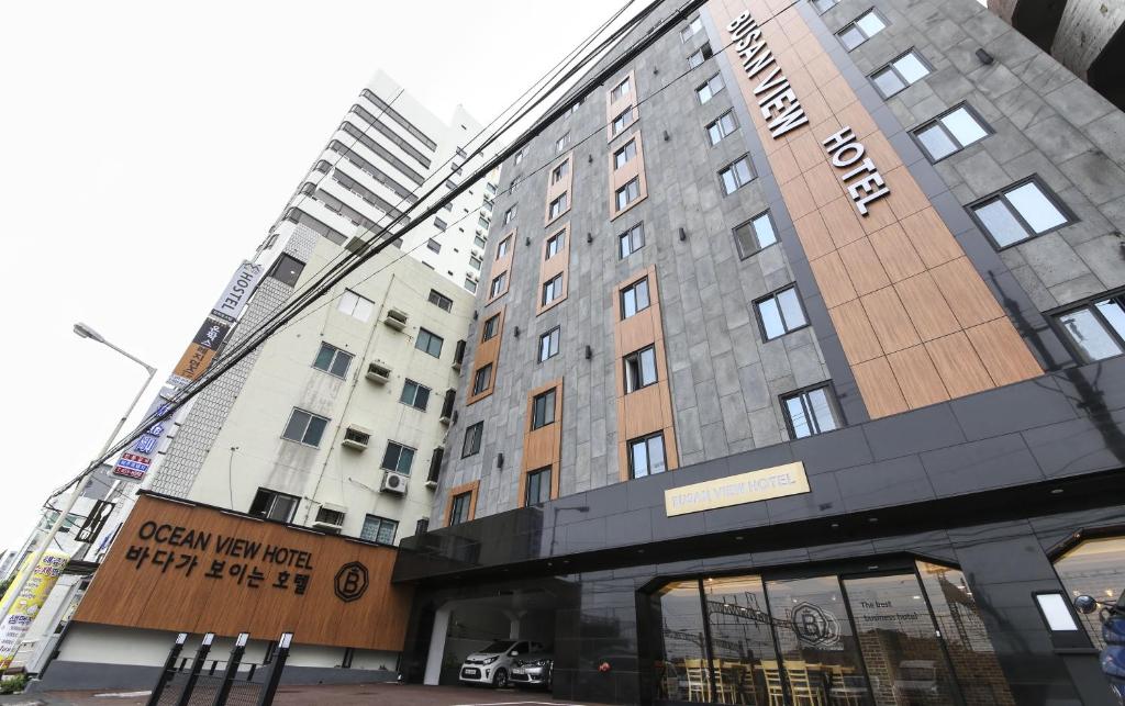 a tall building with a sign on the front of it at Busan Station BUSAN VIEW HOTEL in Busan