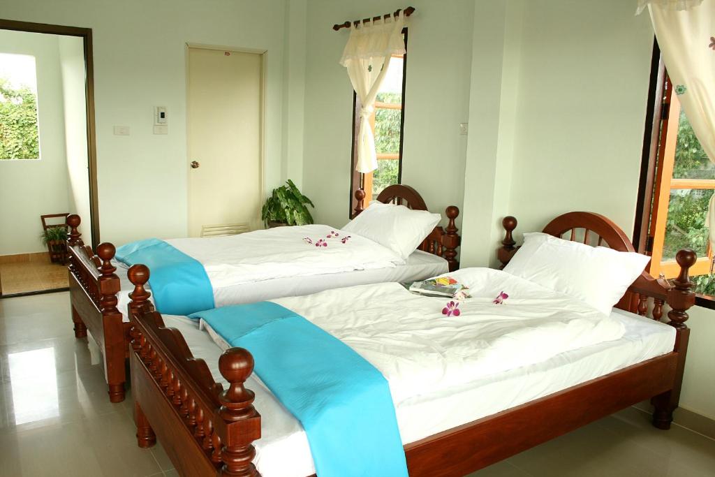 Postel nebo postele na pokoji v ubytování Thai Guesthouse