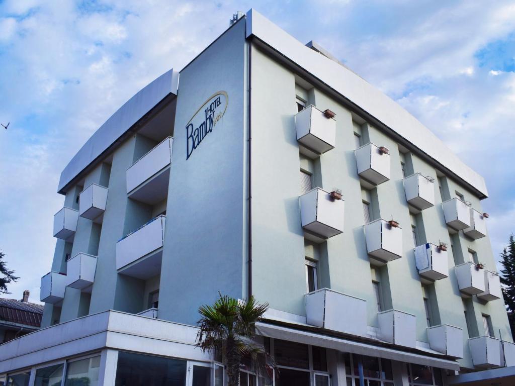 a building with a hotel sign on the side of it at Hotel Bamby in Rimini