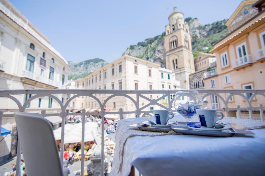 a table with a white table cloth and a glass at Hotel Fontana in Amalfi