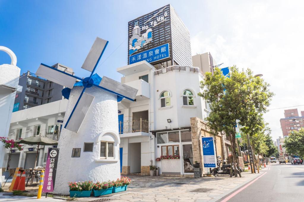 a windmill in front of a white building at Youngs Hotspring Hotel in Jiaoxi