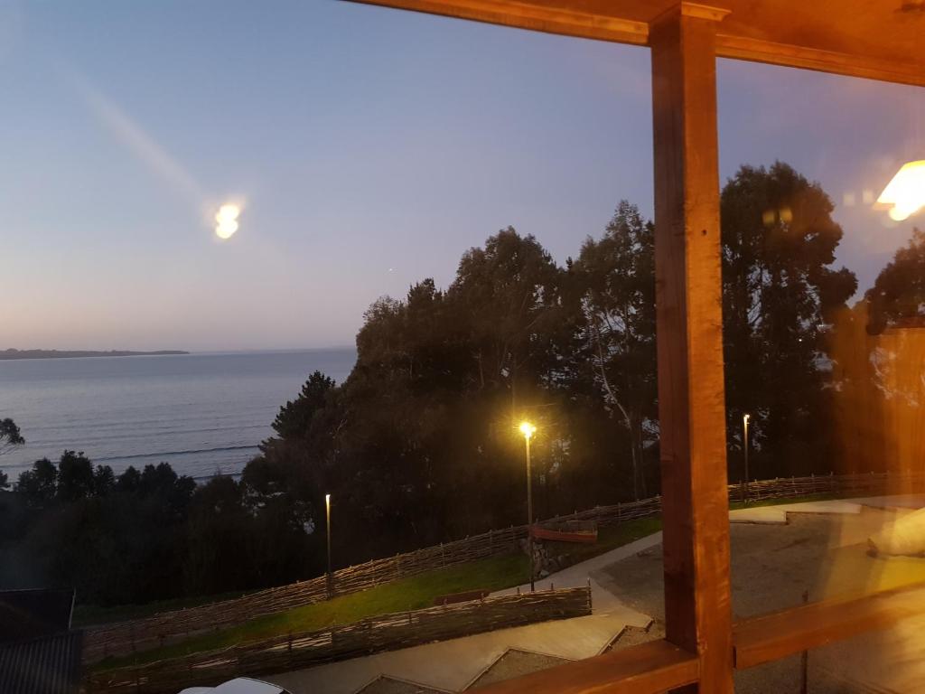 a view of the ocean from a window at Hotel y Cabañas Terrazas Vista al Mar hct in Ancud