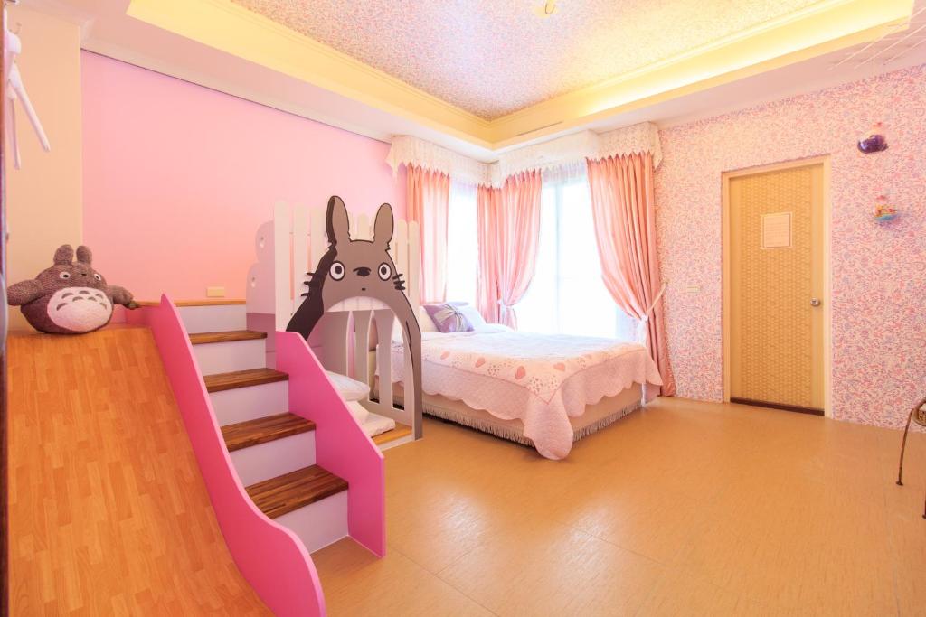 a bedroom with a bed with a bunny on it at Elegance House in Wujie