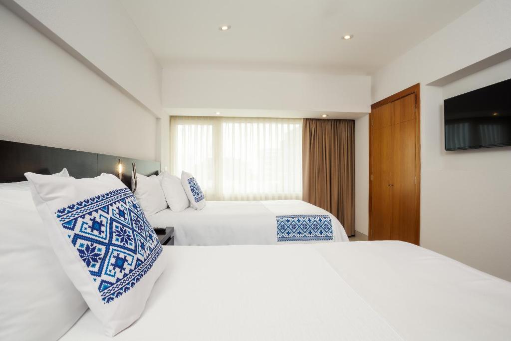 Postel nebo postele na pokoji v ubytování Hotel Indigo Guadalajara Expo by IHG