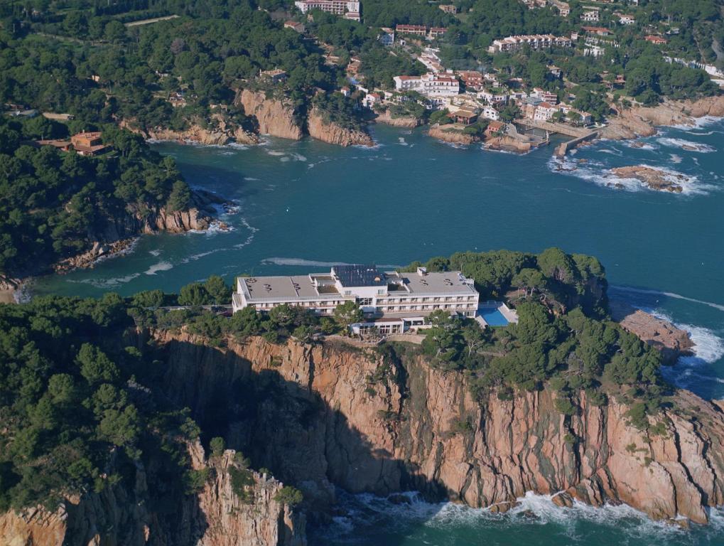 an aerial view of a house on a cliff at Parador de Aiguablava in Begur