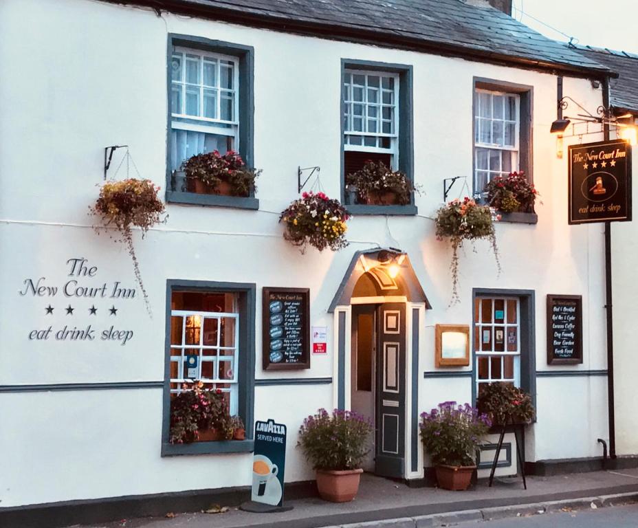 a white building with flowers in the window at The New Court Inn in Usk